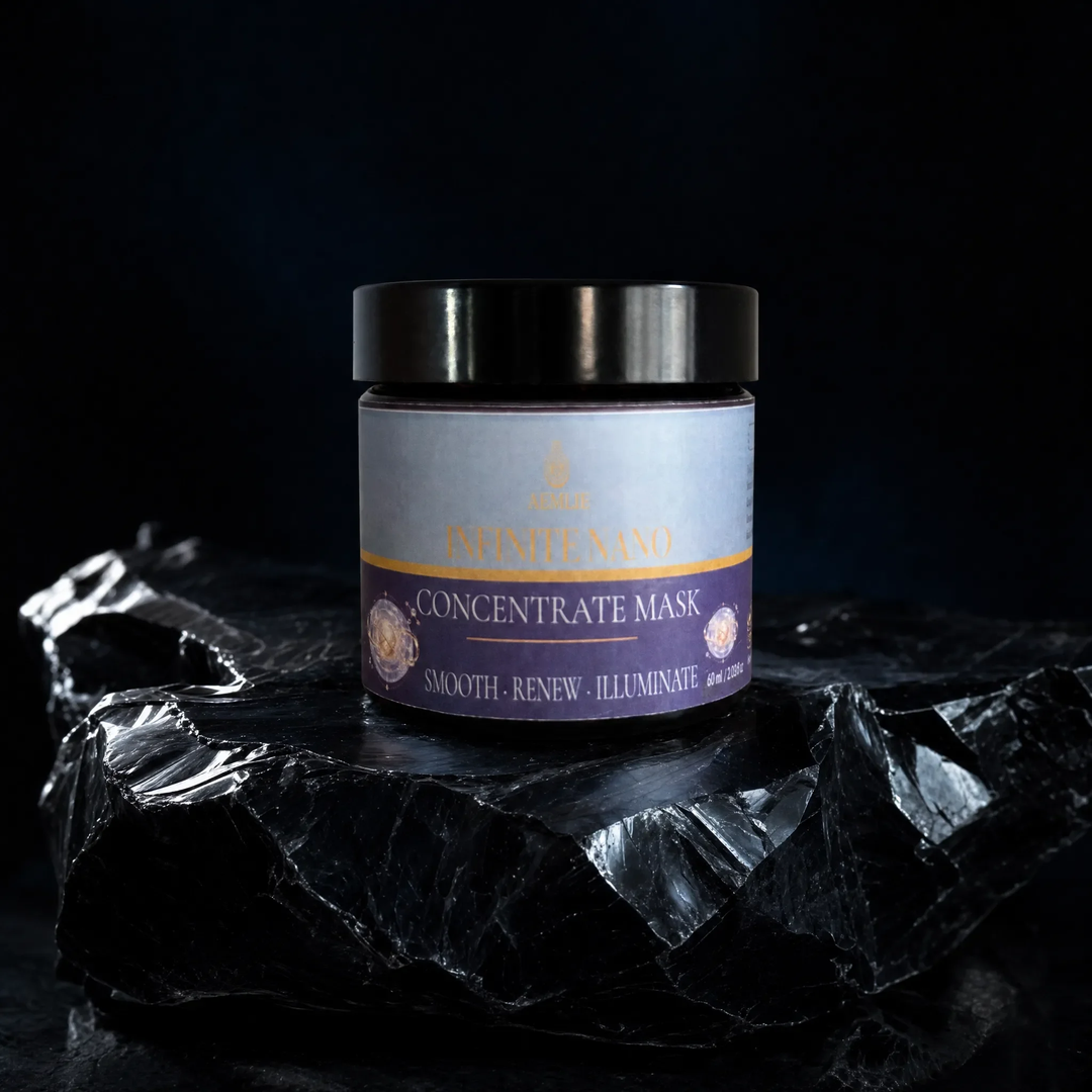 A jar of Imanteno Concentrate Mask with a black lid and a lavender and gold label, displayed on a dark, reflective rock against a black background.