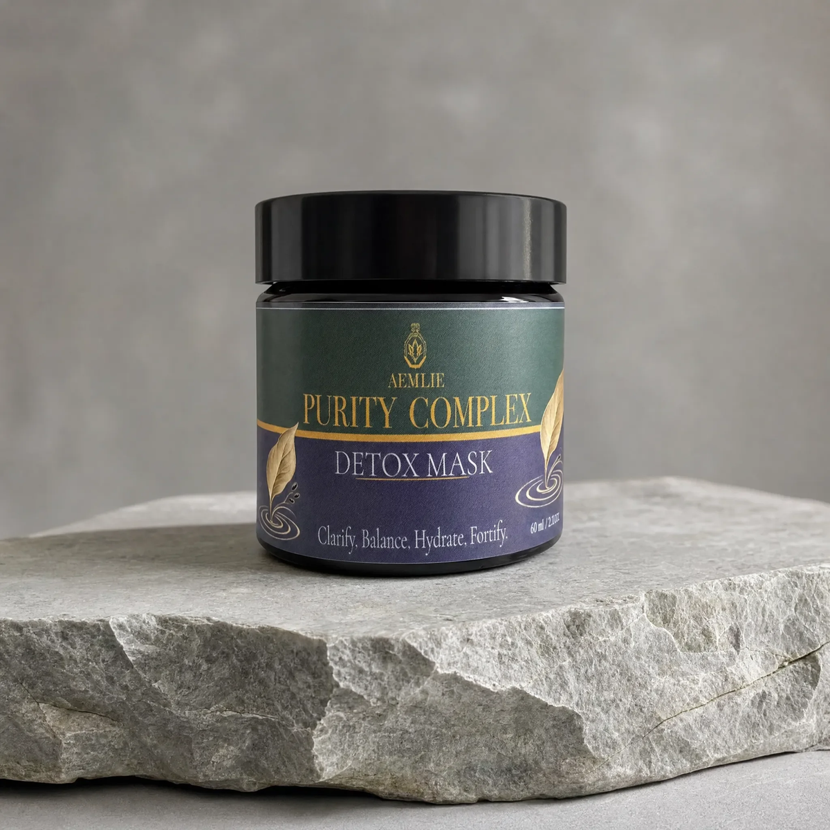 A jar of Neillie Purity Complex Detox Mask sits on a textured gray stone slab against a neutral gray background.