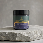 A jar of Neillie Purity Complex Detox Mask sits on a textured gray stone slab against a neutral gray background.